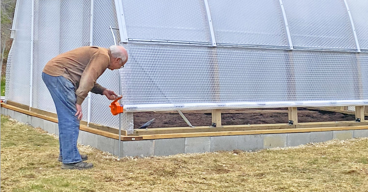 Solawrap-Argenta-Greenhouse-with-roll-up-vents A customer rolls up the side vents of his new Solawrap 4-20 Argenta Greenhouse in Hills BC.